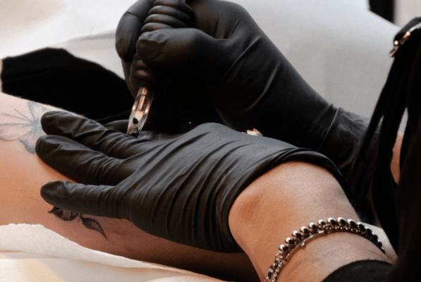 tattoo artist tattooing a client