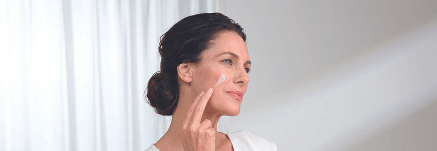 Woman layering skincare