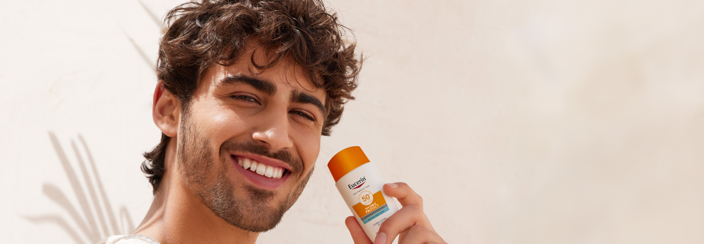 man using Eucerin sunscreen