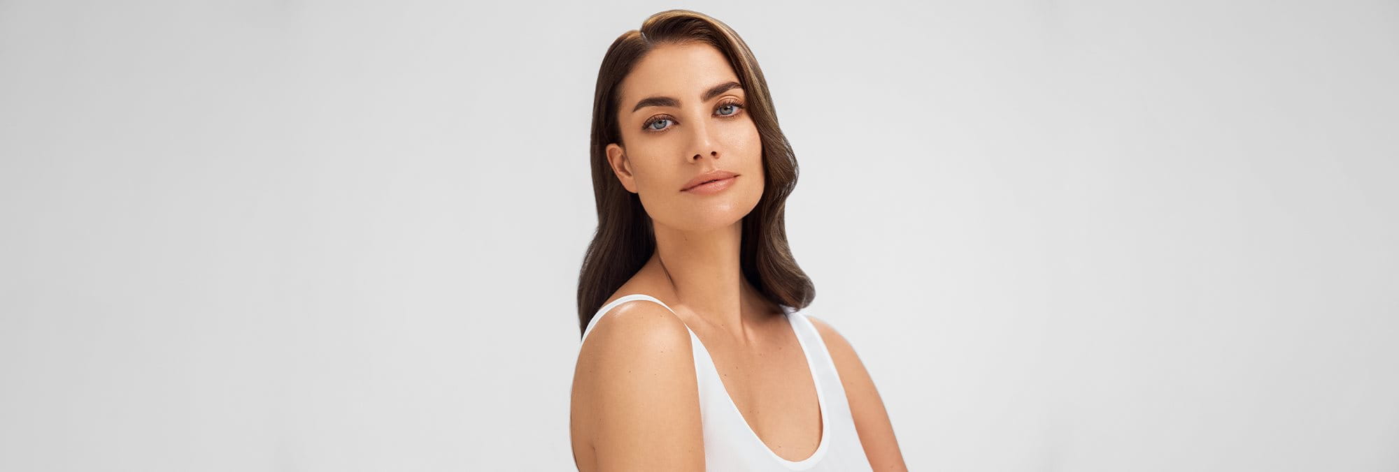 A woman with makeup applied on her acne prone skin - Eucerin