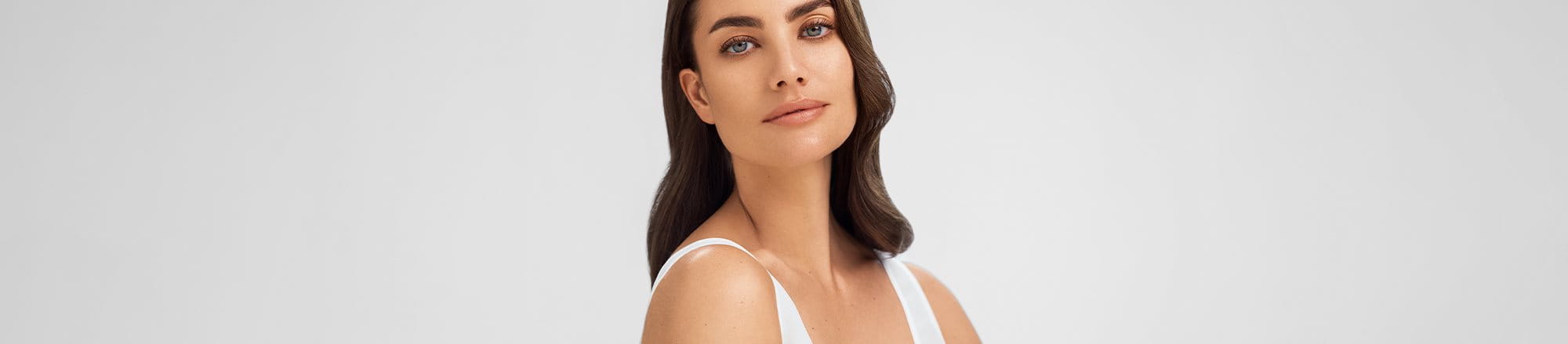 A woman with makeup applied on her acne prone skin - Eucerin