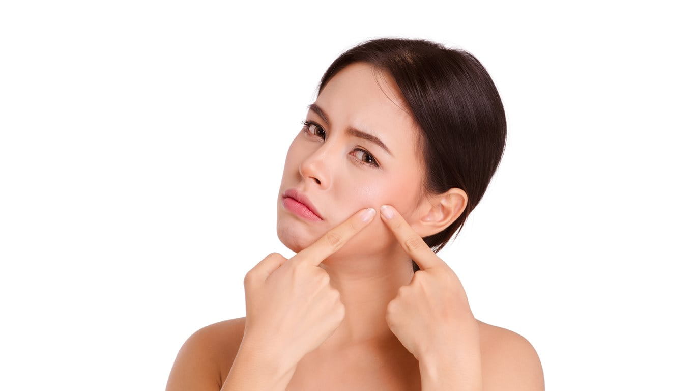 Pressing acne spot