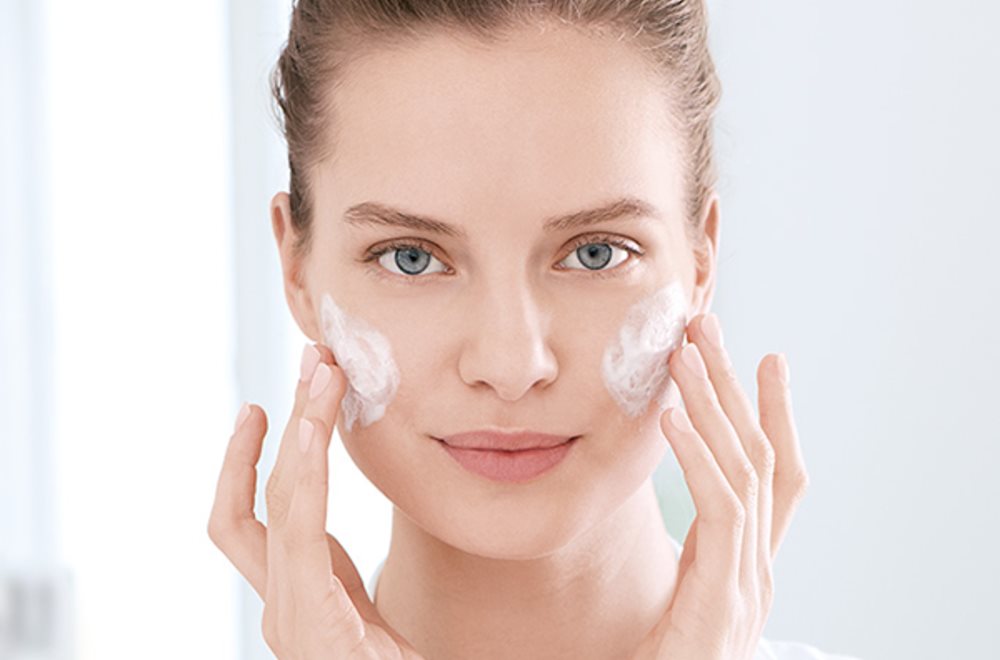 woman cleansing face