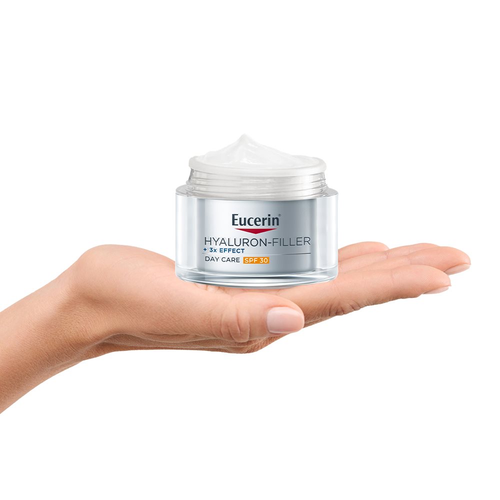 image of a persons hand holding Eucerin Hylauron-Filler Day Care SPF 30 on a white background