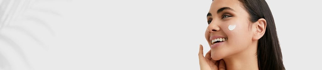 Women Applying Eucerin Sunscreen