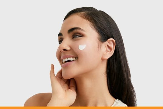 Women Applying Eucerin Sunscreen