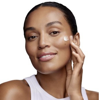 Woman using moisturizer on her face