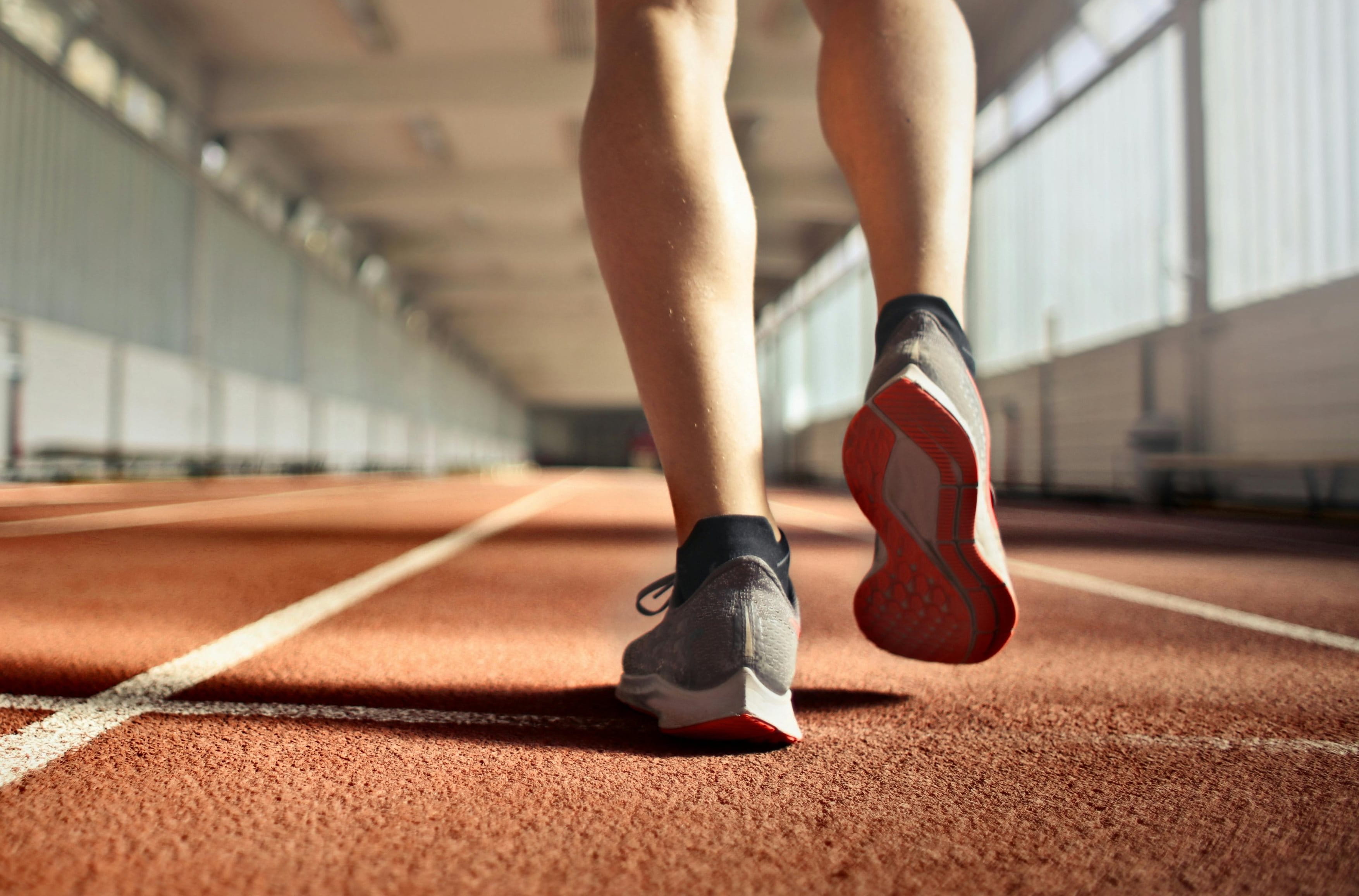 Person getting ready to run in an athletics track