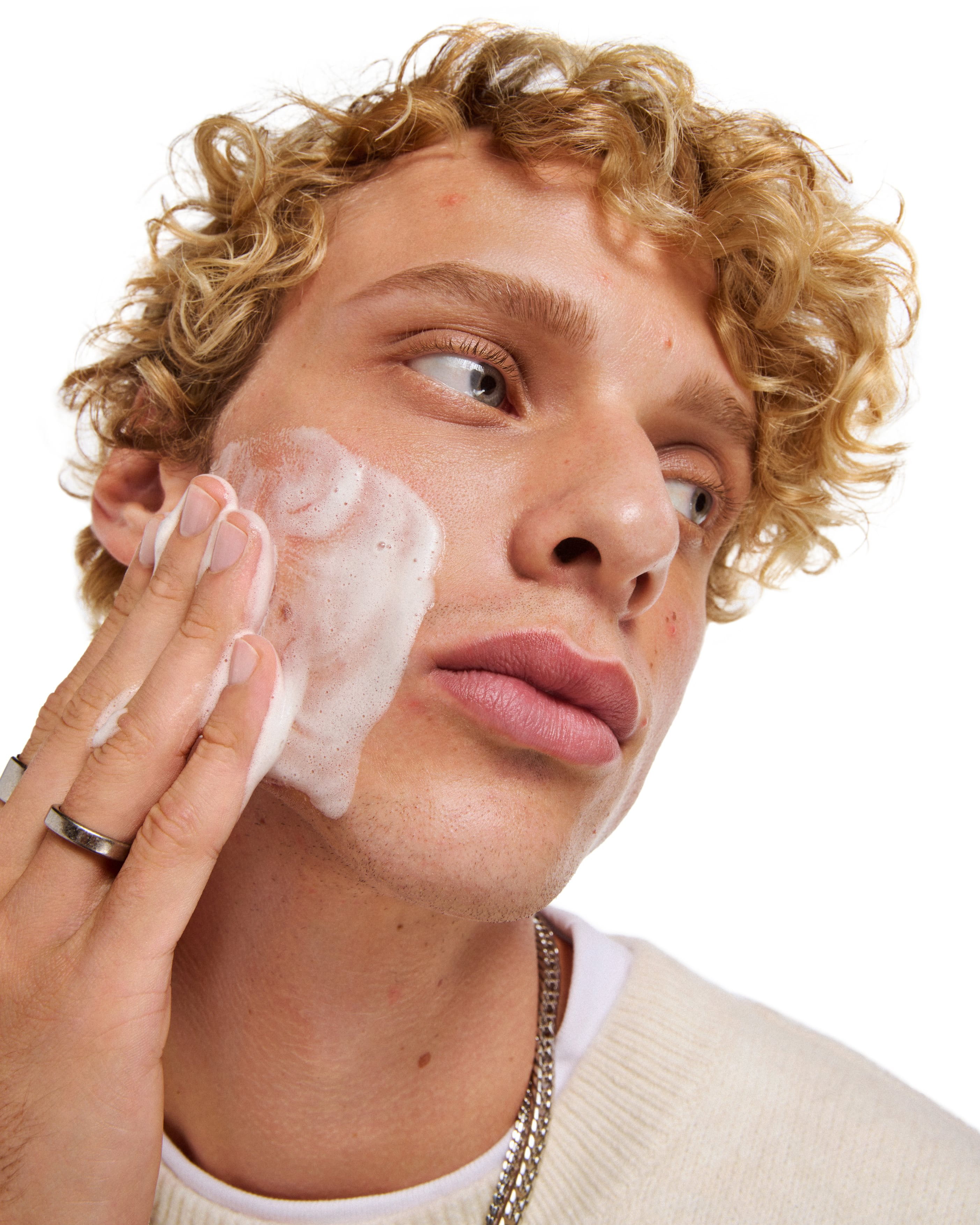 A close-up of a man washing his face