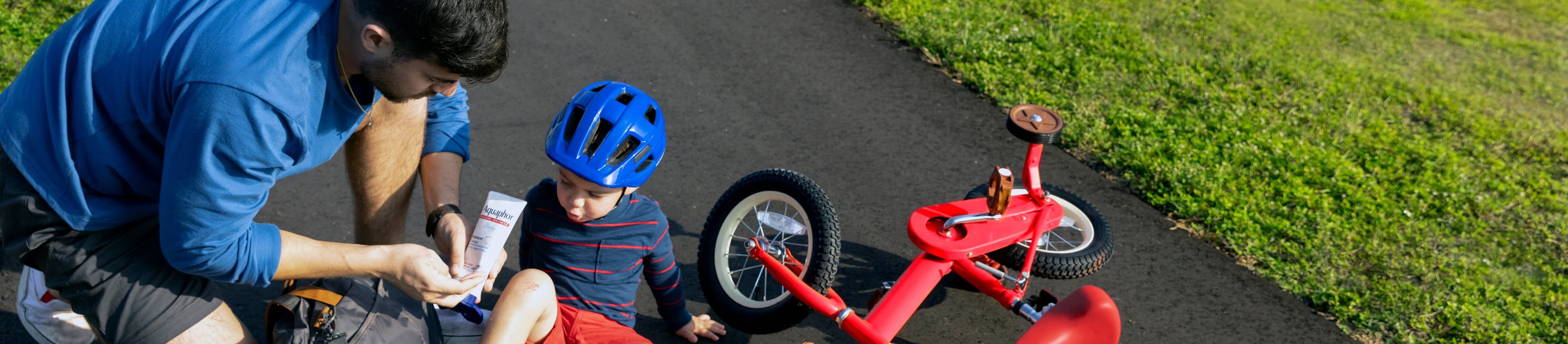 man applying Aquaphor on scrape