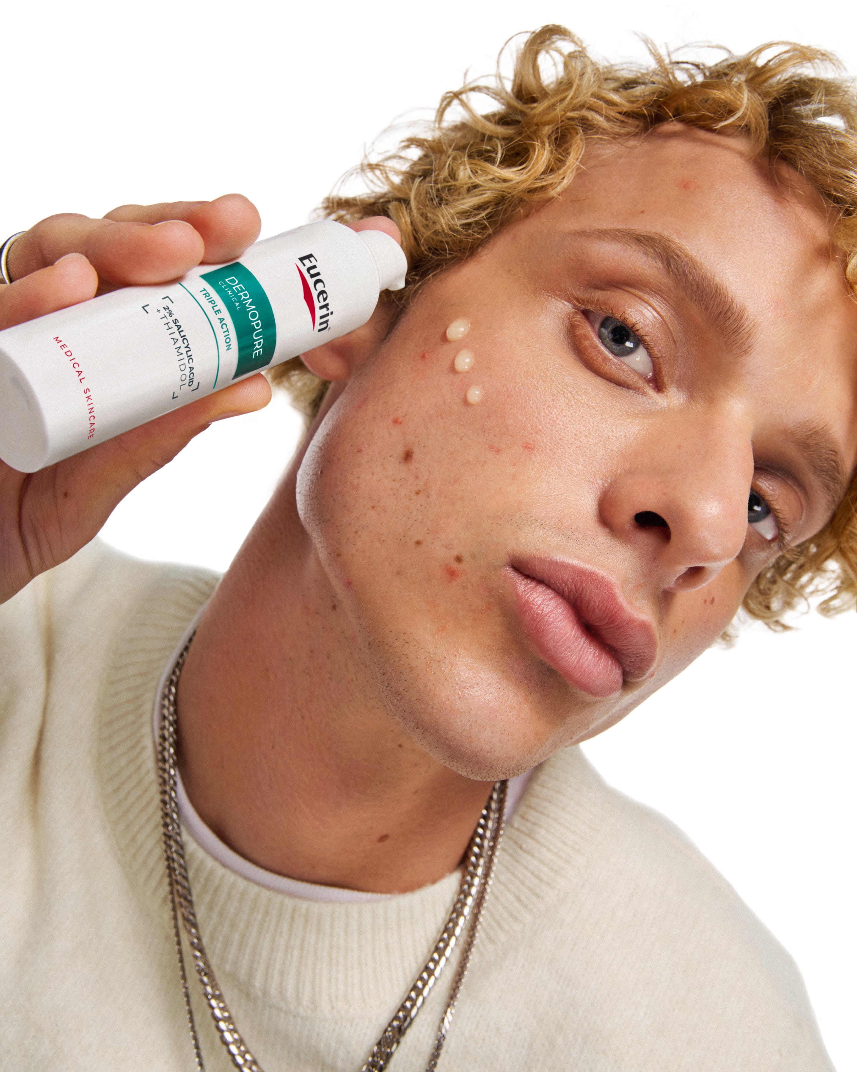 A man using eucerin dermopure clinical triple action for blemish-prone skin