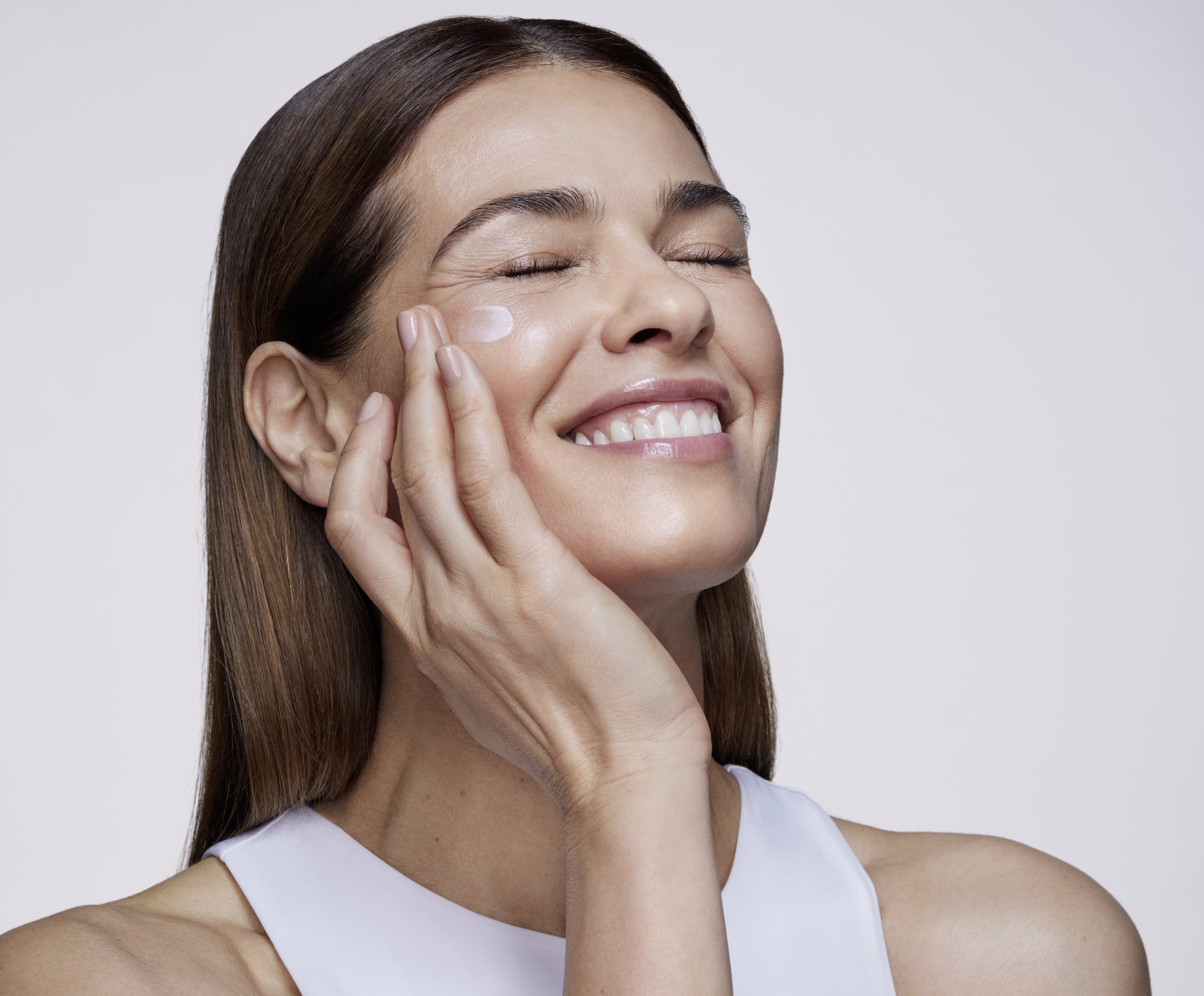 Woman touching her face smiling