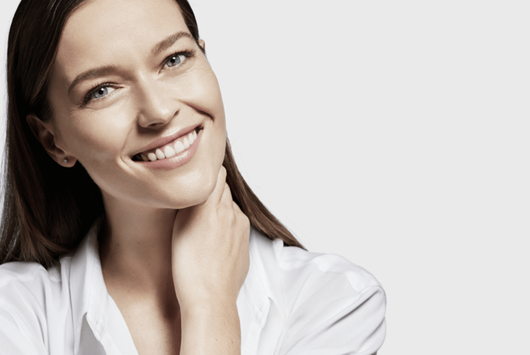 Woman smiling with visible nasolabial folds