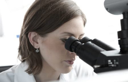 Woman looking into the microscope
