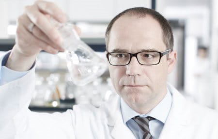 Male scientist holding a test glass