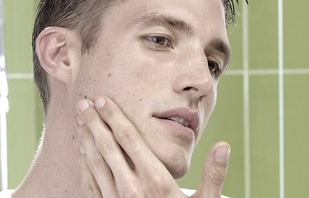 Man applying cream on his face