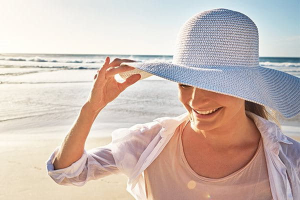 žena sa šeširom na plaži