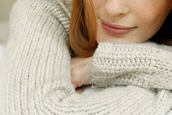 A woman in a cosy knit jumper