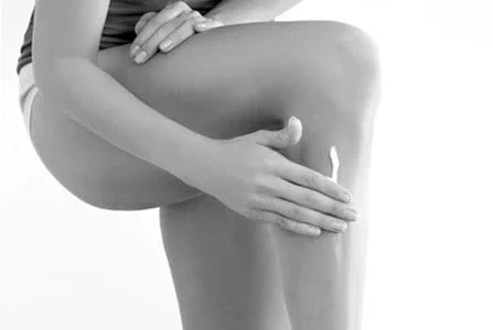 Woman touching her right arm