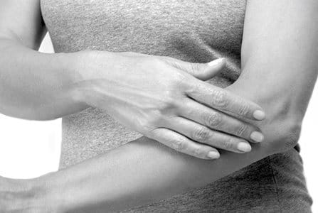 Woman applying cream on her arm