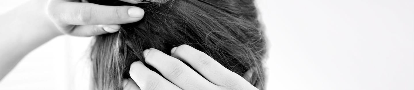 A woman scratching her itchy scalp