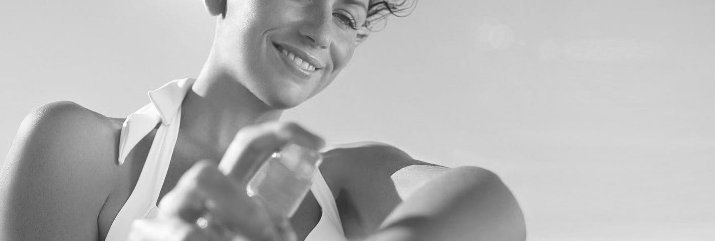 Woman applying sunscreen on her arm