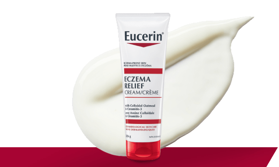 Photo de l’emballage de la Crème Eczema Relief avec une goutte de texture crémeuse à l’arrière-plan