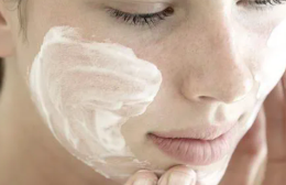 Woman using moisturizer on her face
