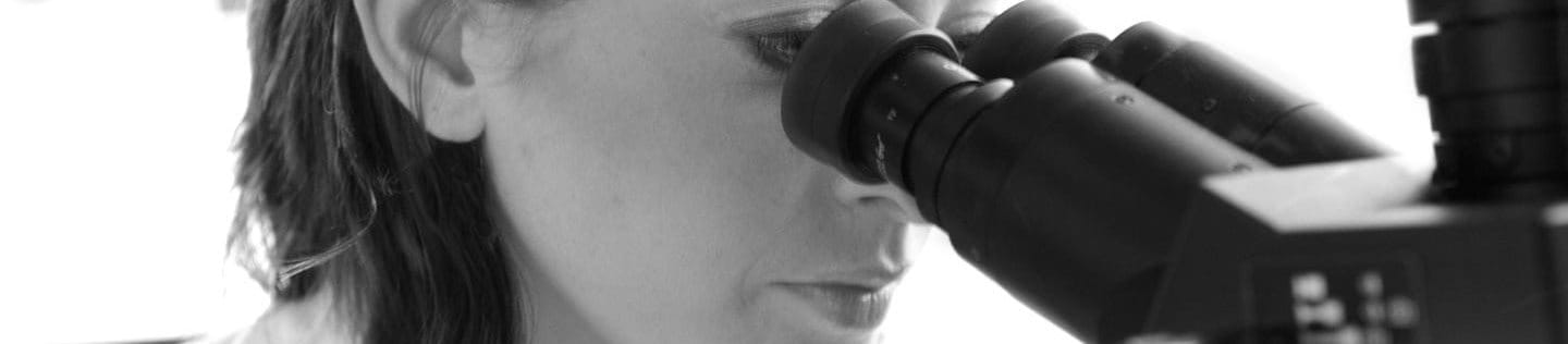 Woman looking through a microscope