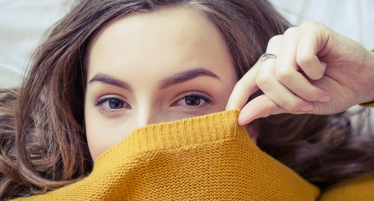 Woman feeling stressed while looking at laptop