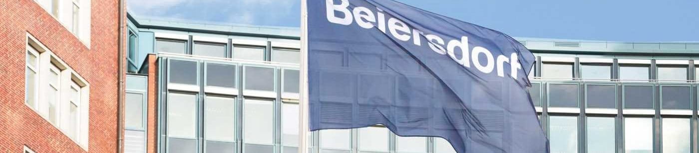 The Beiersdorf head office in Hamburg, in front of it the Beiersdorf company sign.