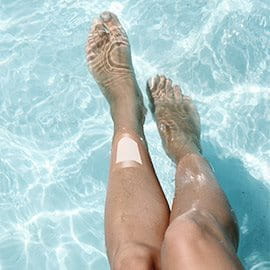 Legs in pool with waterproof wound protection