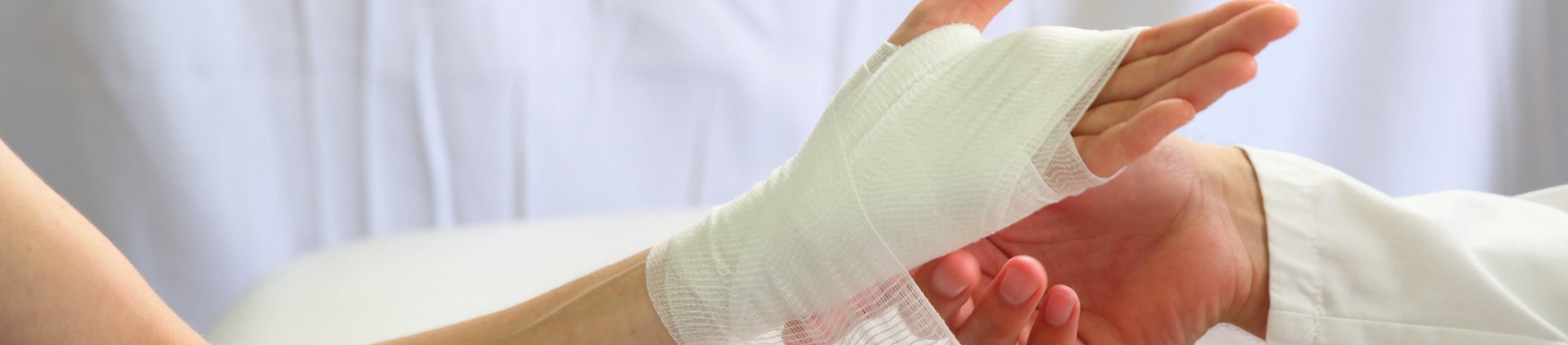 doctor applying bandage to wound