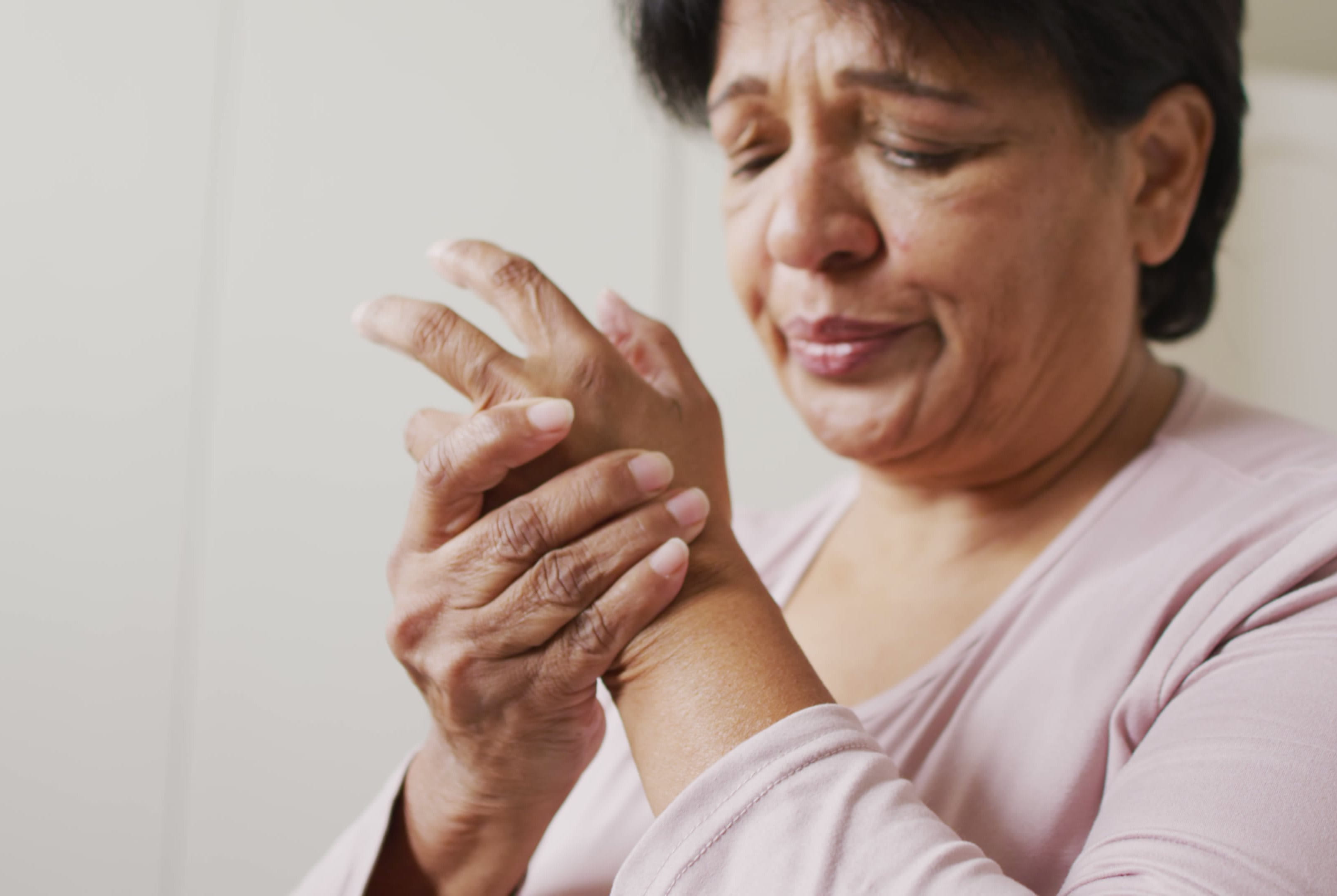 Woman holding her hand in pain