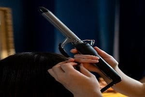 person turning off curling iron