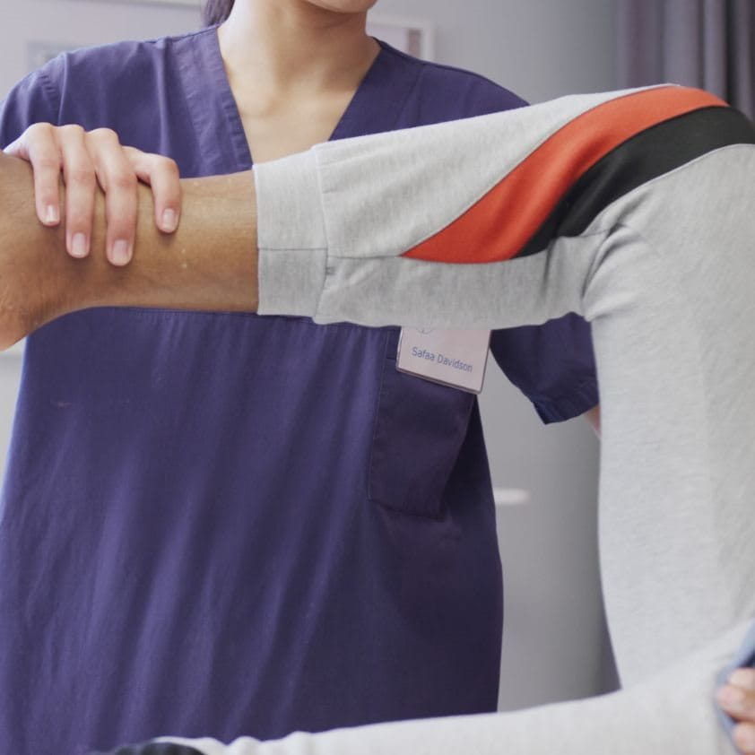 a doctor lifting up a person's leg for elevation